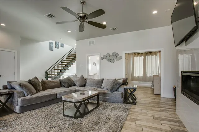 a living room with furniture ceiling fan and a rug