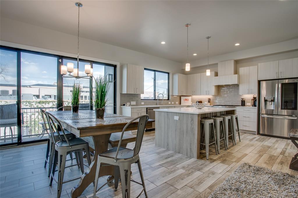 410 Melba Street, Unit 2 Dallas, TX 75208 - Photo 14 of 40 a kitchen with kitchen island a dining table chairs and wooden floor