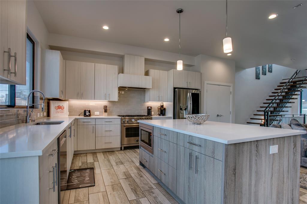 410 Melba Street, Unit 2 Dallas, TX 75208 - Photo 15 of 40 a kitchen with a sink stove and cabinets