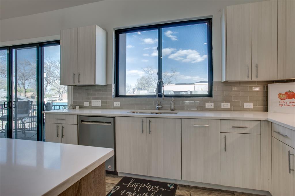 410 Melba Street, Unit 2 Dallas, TX 75208 - Photo 16 of 40 a kitchen with stainless steel appliances granite countertop a stove a sink and white cabinets