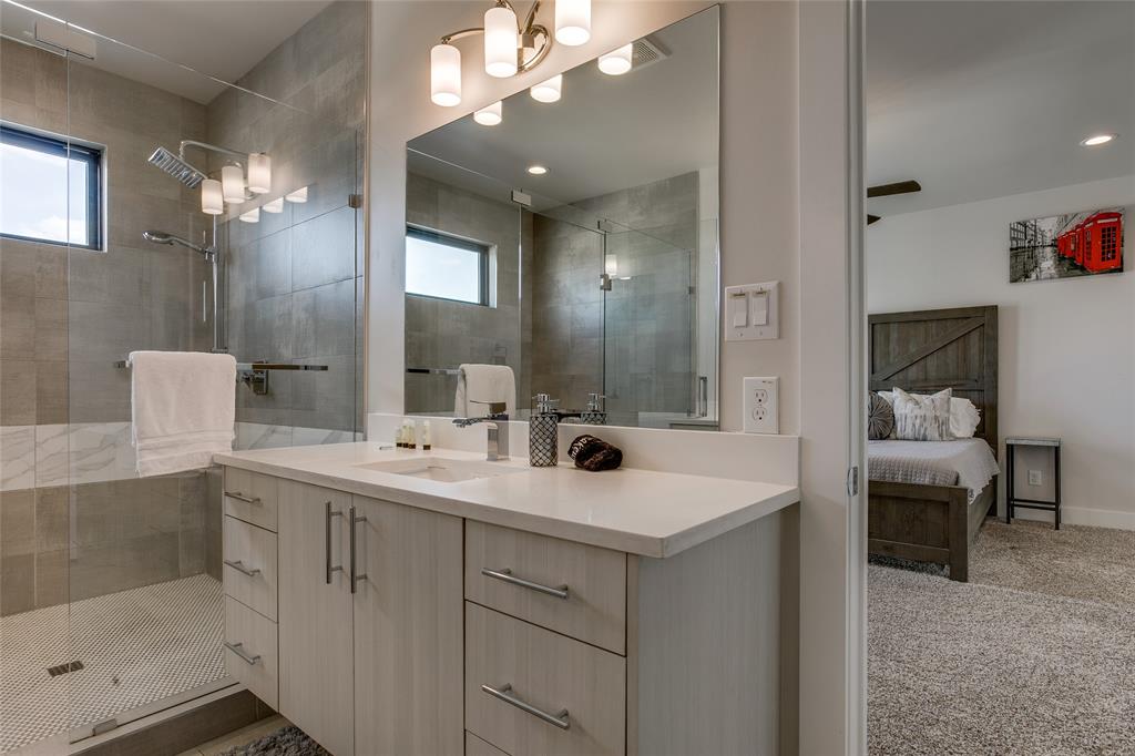 410 Melba Street, Unit 2 Dallas, TX 75208 - Photo 26 of 40 a bathroom with a sink a light fixture and a mirror