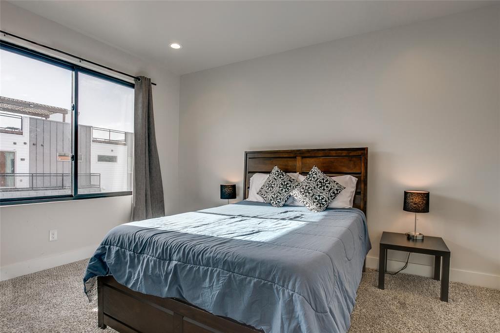 410 Melba Street, Unit 2 Dallas, TX 75208 - Photo 29 of 40 a bed sitting in a bedroom next to a window