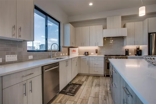 a kitchen with a sink stove and cabinets