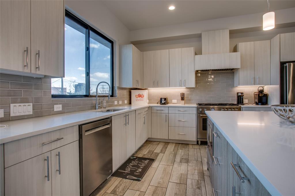 410 Melba Street, Unit 2 Dallas, TX 75208 - Photo 5 of 40 a kitchen with a sink stove and cabinets