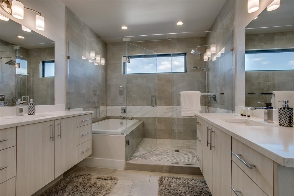 410 Melba Street, Unit 2 Dallas, TX 75208 - Photo 7 of 40 a bathroom with a double vanity sink a large mirror and a bathtub