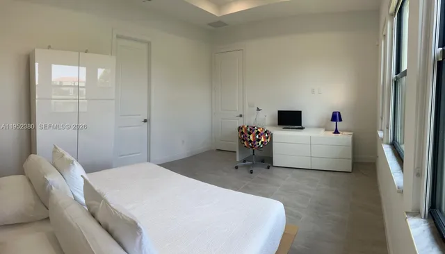 a bedroom with a bed and a couch