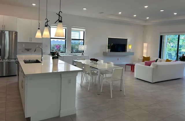 a large kitchen with a table and chairs