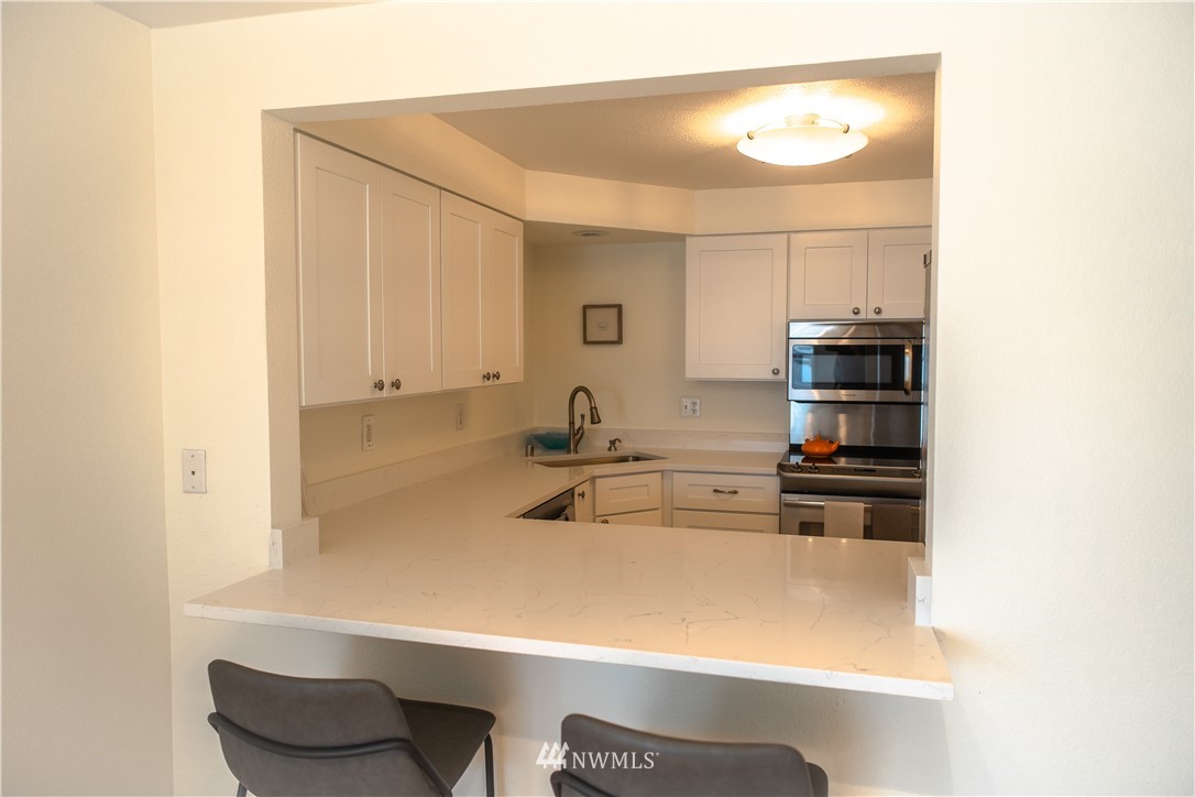 3733 Waller Road East, Unit 301 Tacoma, WA 98443 - Photo 11 of 17 a kitchen with a sink and a refrigerator