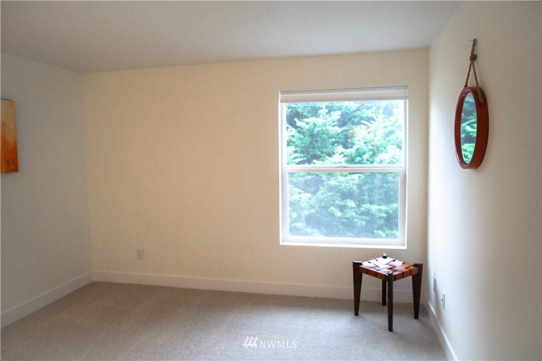 3733 Waller Road East, Unit 301 Tacoma, WA 98443 - Photo 12 of 17 an empty room with windows wooden table and chair