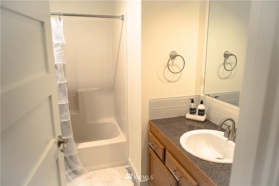 3733 Waller Road East, Unit 301 Tacoma, WA 98443 - Photo 14 of 17 a bathroom with a granite countertop sink toilet and shower