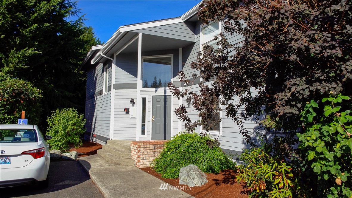 3733 Waller Road East, Unit 301 Tacoma, WA 98443 - Photo 2 of 17 a front view of a house with garden