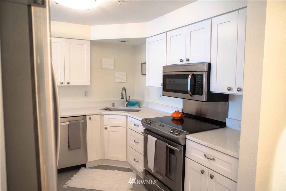 3733 Waller Road East, Unit 301 Tacoma, WA 98443 - Photo 9 of 17 a kitchen with cabinets appliances and a sink