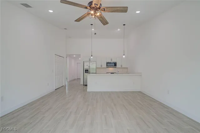a kitchen with stainless steel appliances a refrigerator sink and microwave