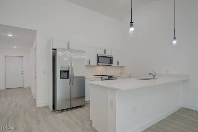 a kitchen with stainless steel appliances a refrigerator and a stove