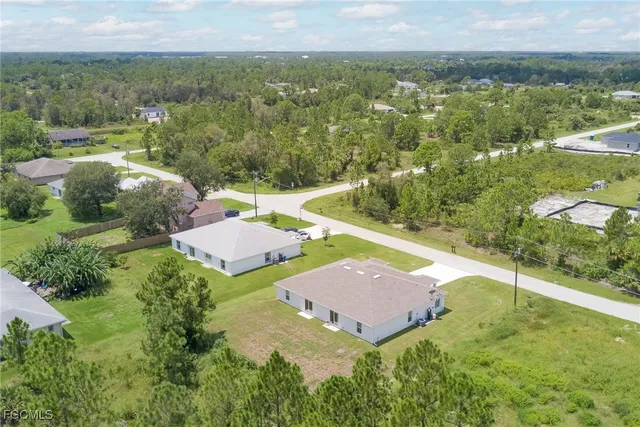 an aerial view of residential houses with outdoor space and river