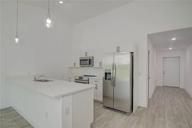 a kitchen with stainless steel appliances a refrigerator and a sink