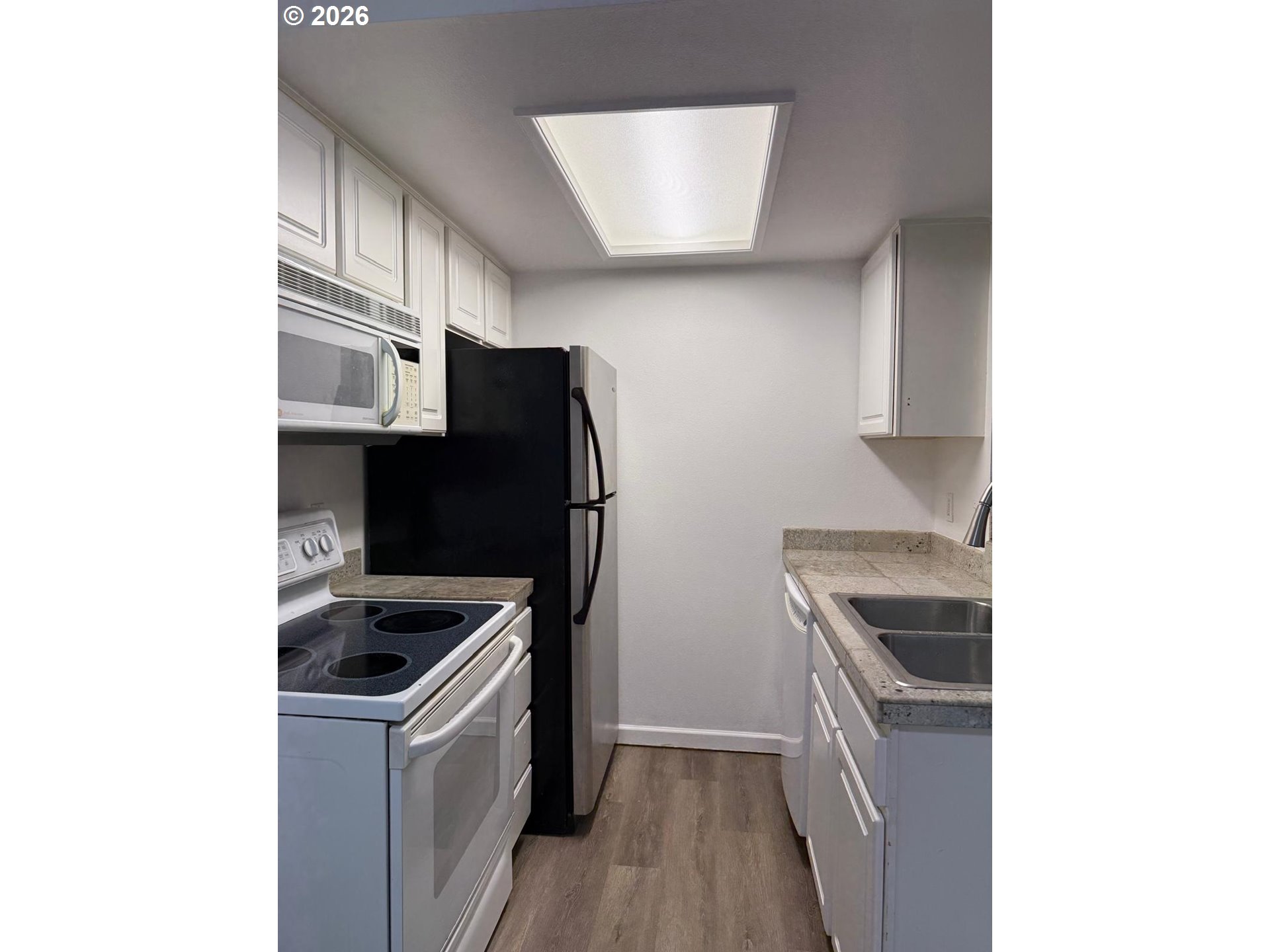 9987 Southeast Talbert Street Clackamas, OR 97015 - Photo 8 of 14 a kitchen with a refrigerator and a sink