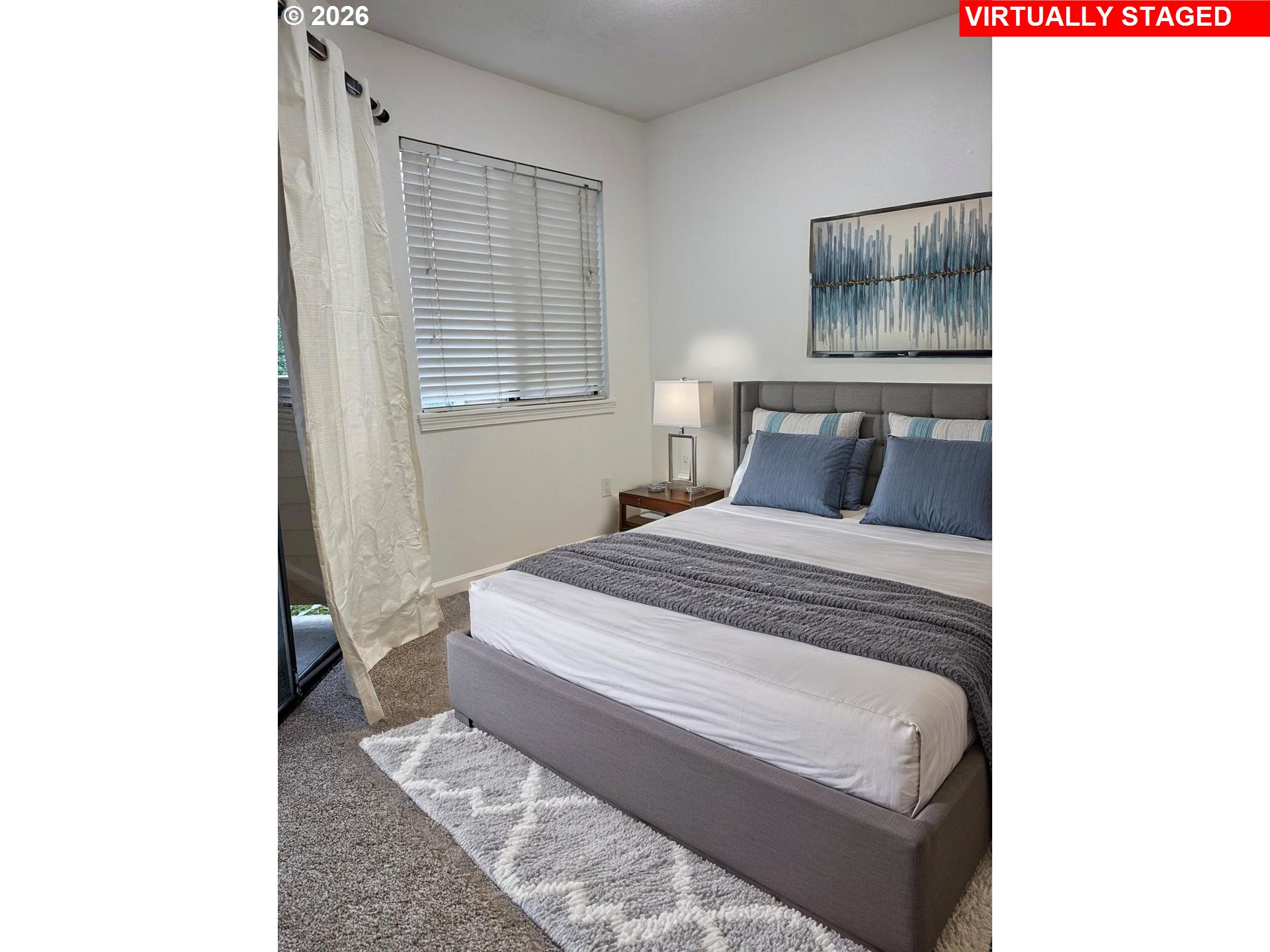 9987 Southeast Talbert Street Clackamas, OR 97015 - Photo 10 of 14 a bedroom with a bed and a window