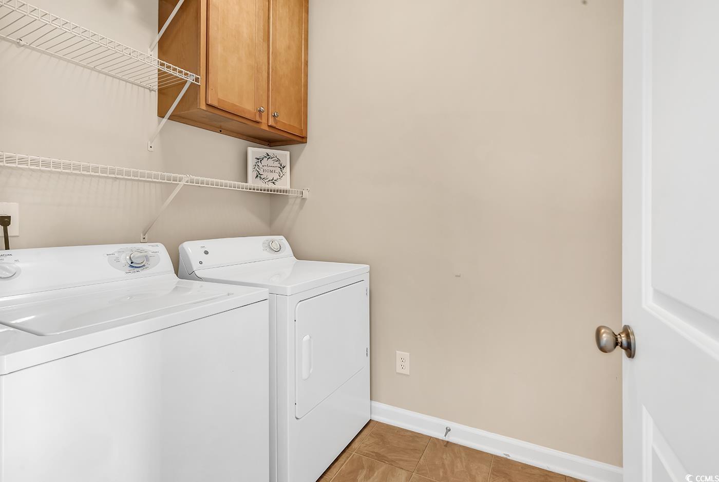 126 Dreamland Drive Murrells Inlet, SC 29576 - Photo 16 of 40 Laundry room featuring separate washer and dryer, cabinet space, baseboards, and light tile patterned floors