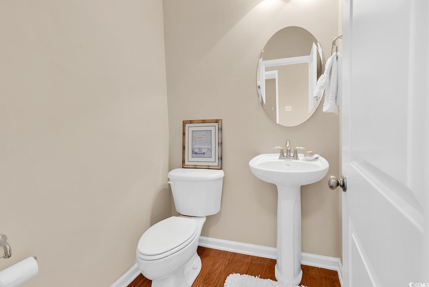 126 Dreamland Drive Murrells Inlet, SC 29576 - Photo 17 of 40 Bathroom with toilet, wood finished floors, baseboards, and a sink