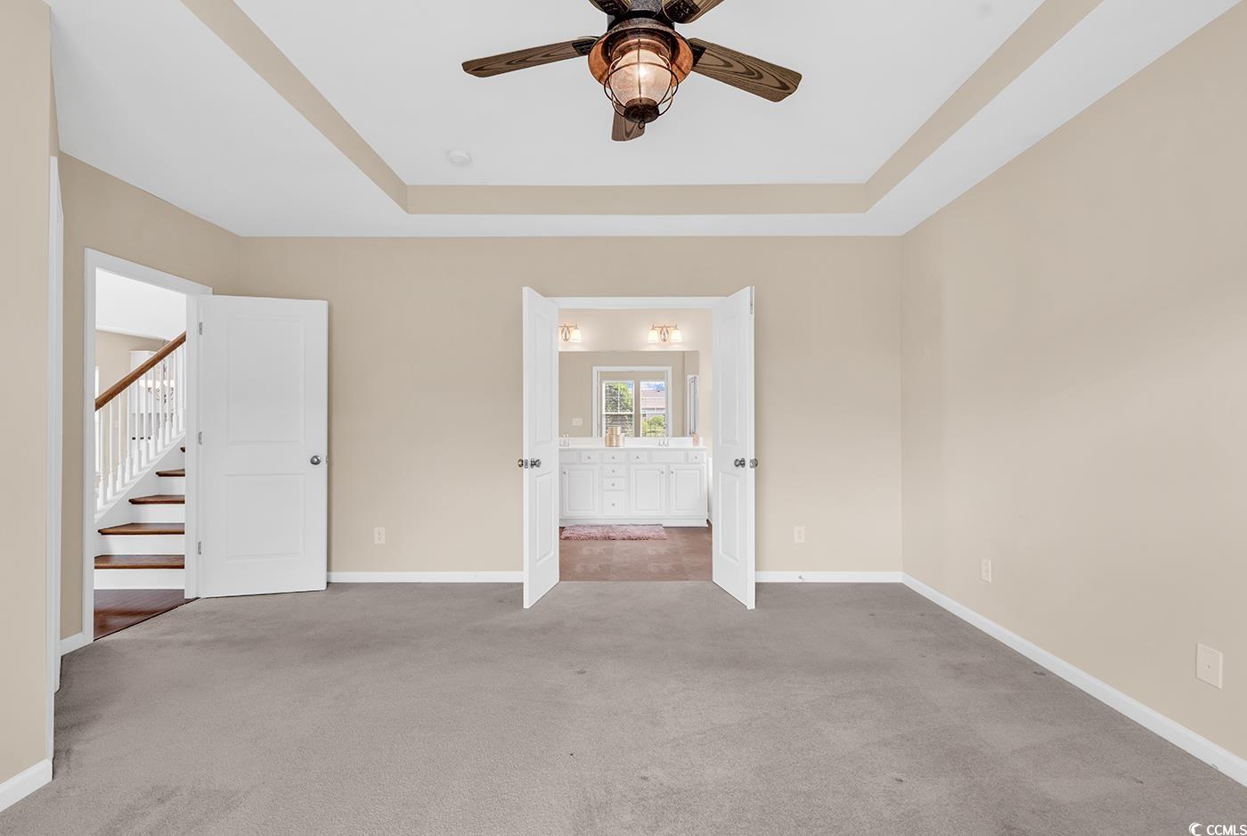 126 Dreamland Drive Murrells Inlet, SC 29576 - Photo 18 of 40 Unfurnished bedroom with carpet flooring, a raised ceiling, baseboards, and ensuite bath