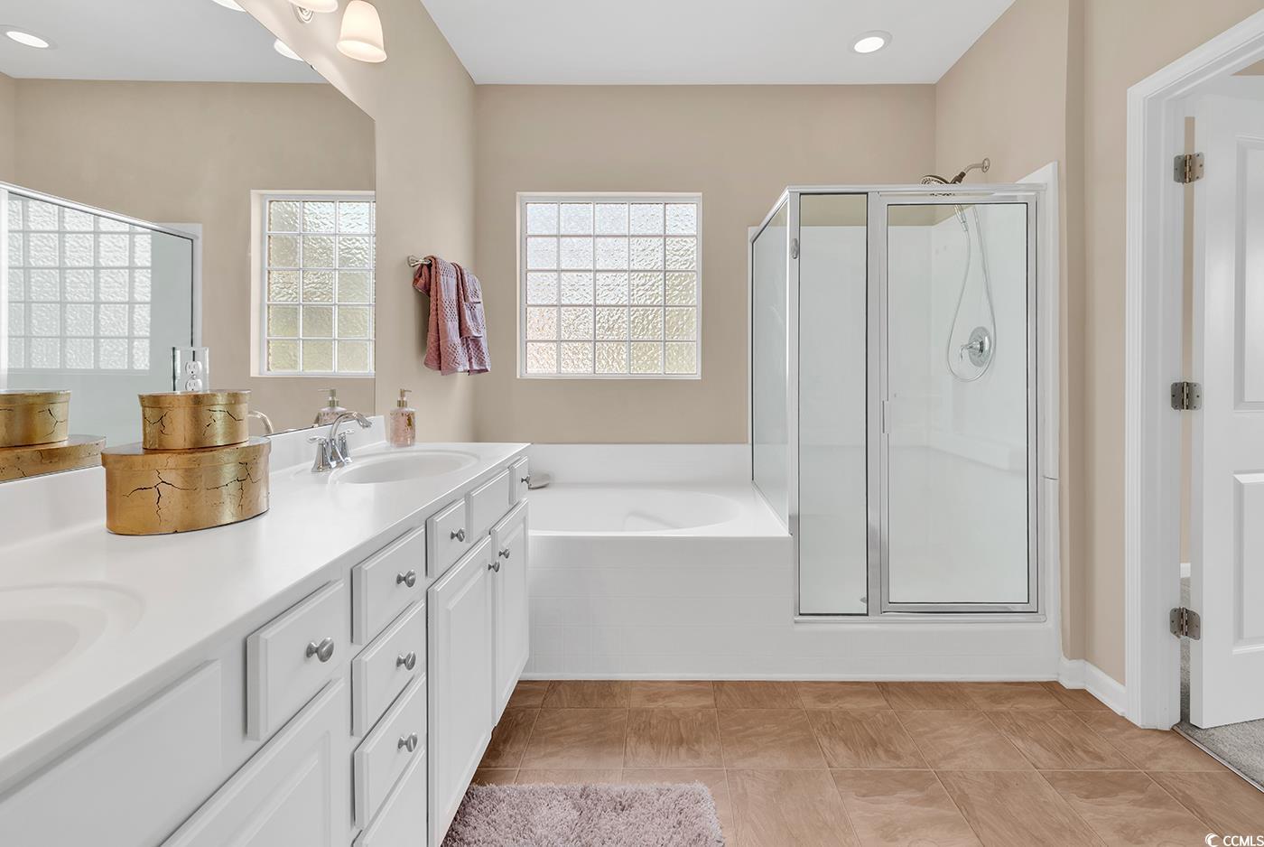 126 Dreamland Drive Murrells Inlet, SC 29576 - Photo 21 of 40 Bathroom featuring a bath, a shower stall, double vanity, and recessed lighting