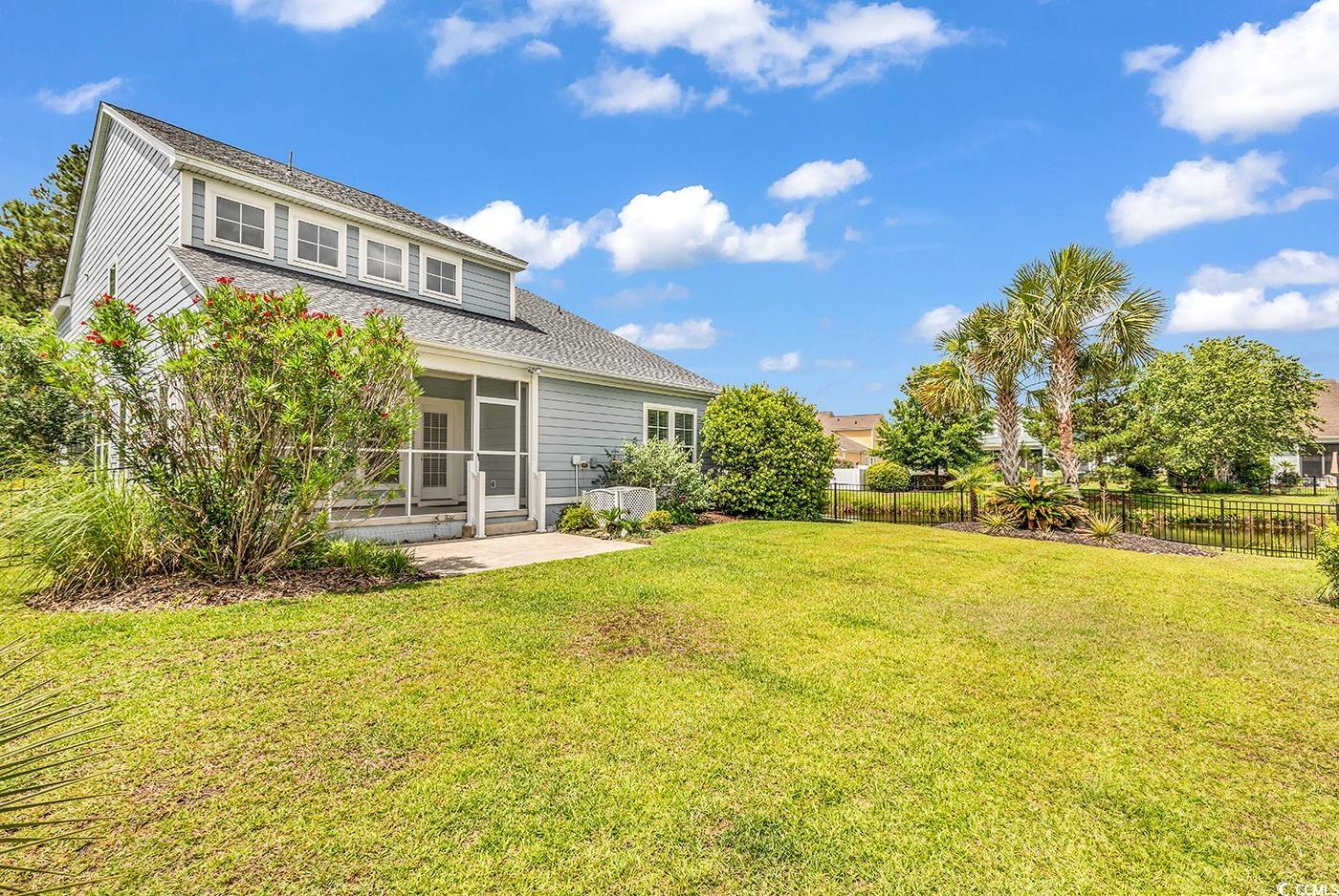 126 Dreamland Drive Murrells Inlet, SC 29576 - Photo 31 of 40 Back of property featuring a patio, a sunroom, and a shingled roof