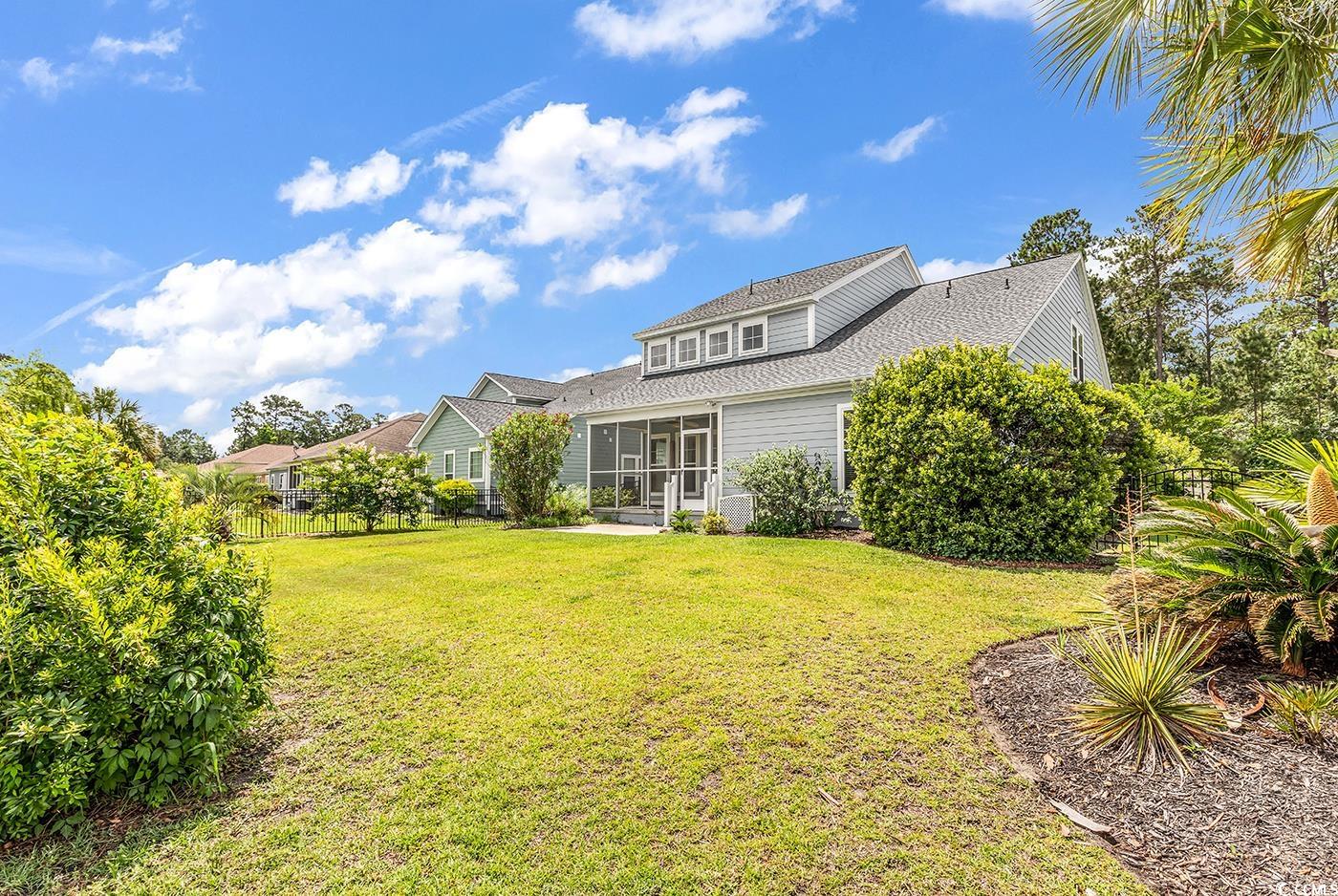 126 Dreamland Drive Murrells Inlet, SC 29576 - Photo 33 of 40 Rear view of house with a sunroom and roof with shingles