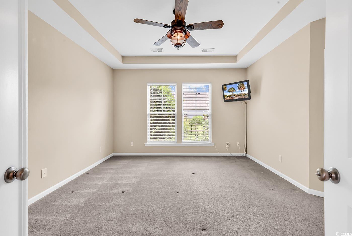 126 Dreamland Drive Murrells Inlet, SC 29576 - Photo 36 of 40 Spare room with a ceiling fan, carpet, a tray ceiling, and baseboards