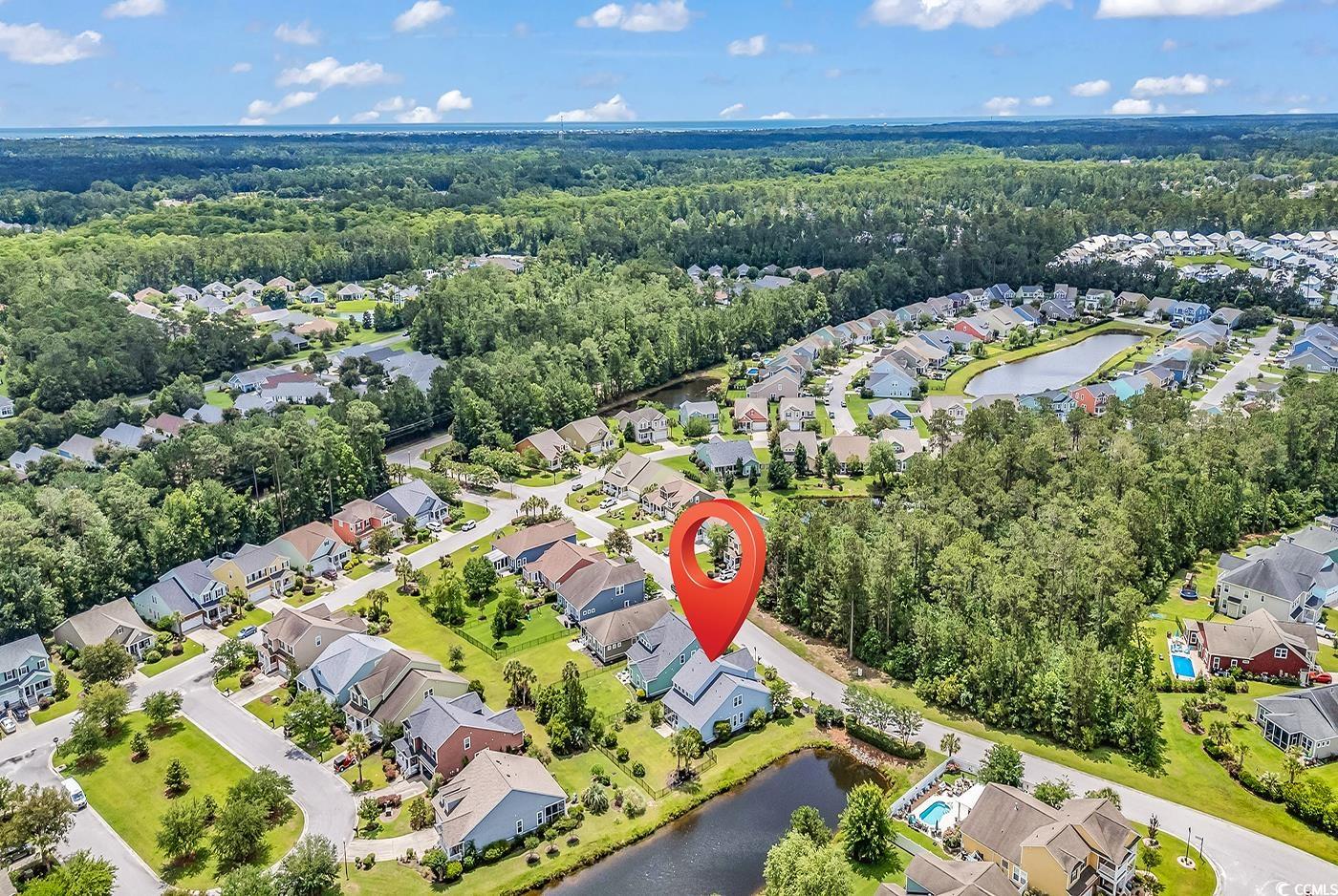 126 Dreamland Drive Murrells Inlet, SC 29576 - Photo 39 of 40 Aerial overview of property's location with nearby suburban area, a nearby body of water, and a heavily wooded area