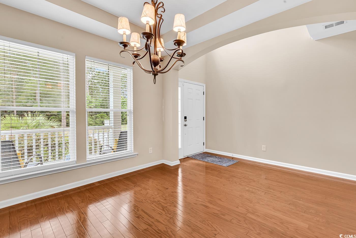 126 Dreamland Drive Murrells Inlet, SC 29576 - Photo 4 of 40 Foyer featuring a chandelier, wood finished floors, baseboards, and arched walkways