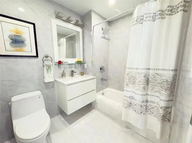 a bathroom with a sink mirror vanity and toilet
