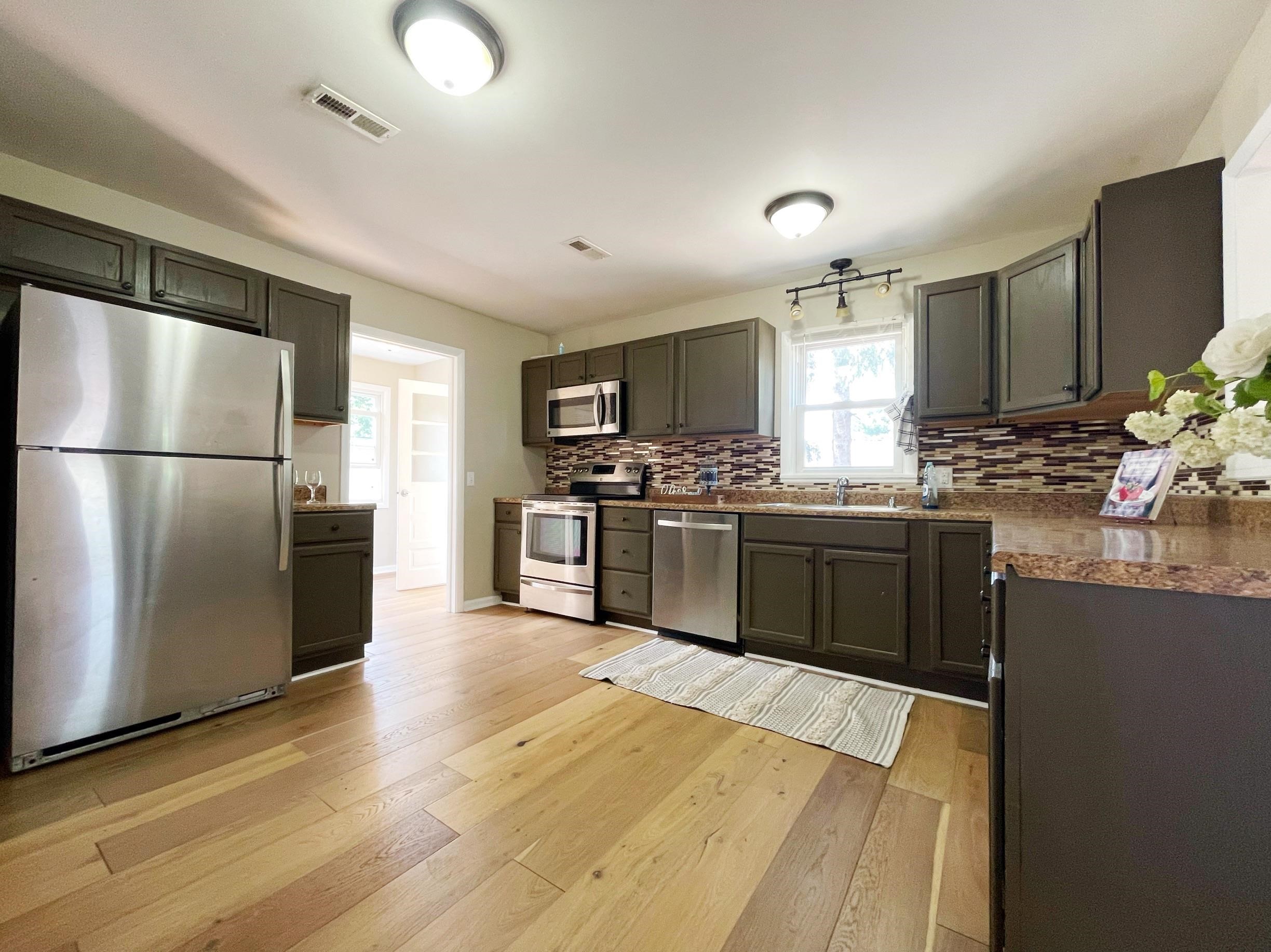 503 5th Street Grottoes, VA 24441 - Photo 12 of 24 a kitchen with stainless steel appliances granite countertop a refrigerator a sink a stove a microwave and wooden floor