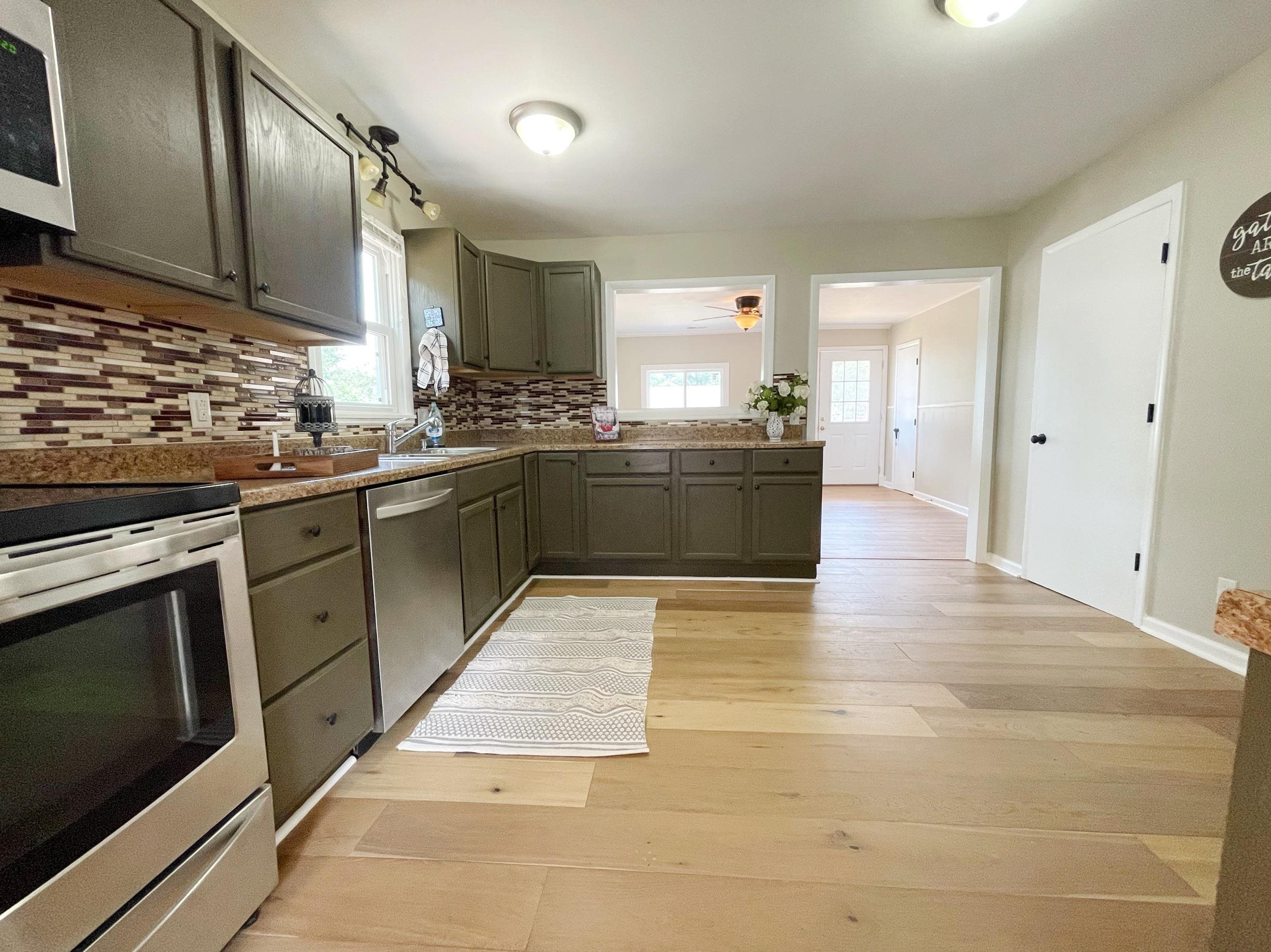 503 5th Street Grottoes, VA 24441 - Photo 13 of 24 a large kitchen with stainless steel appliances granite countertop a stove and a sink