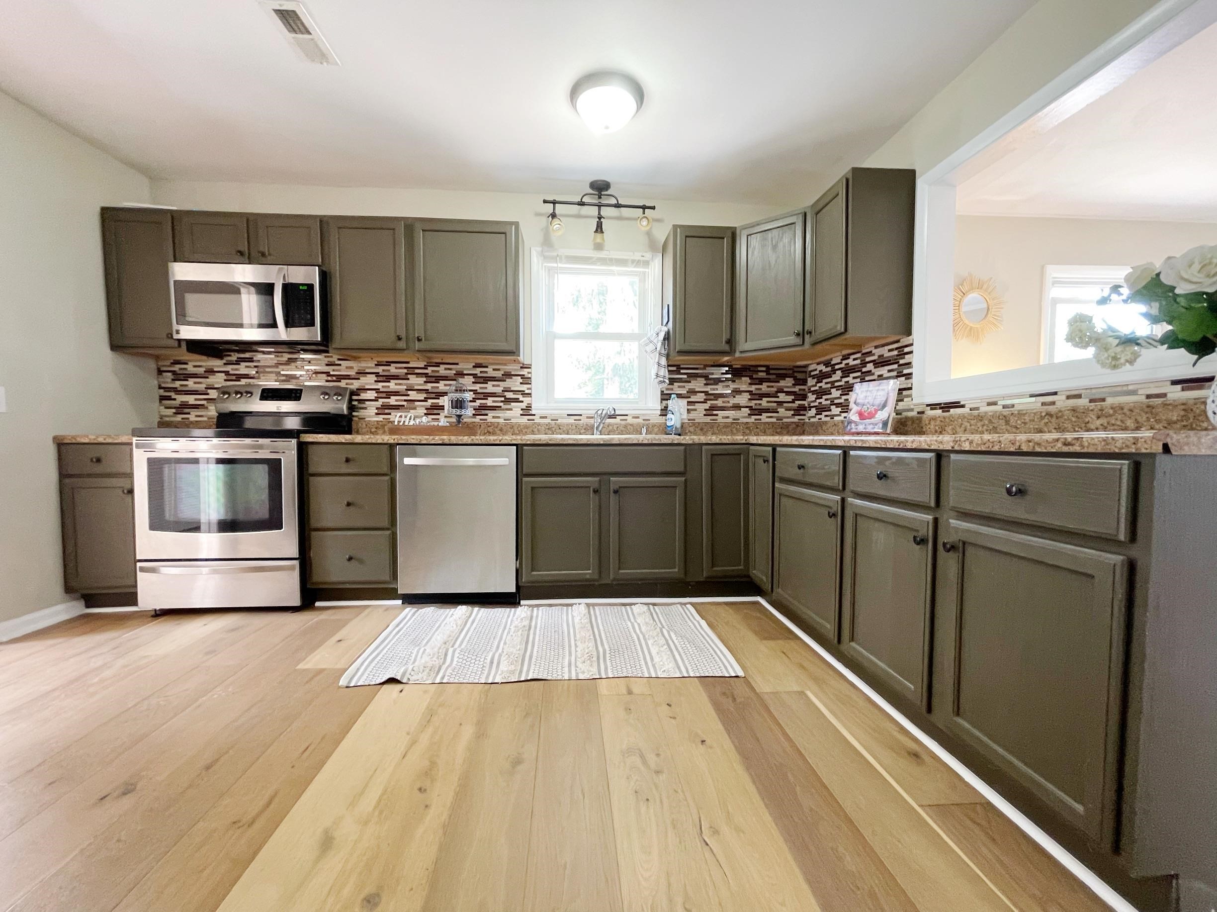 503 5th Street Grottoes, VA 24441 - Photo 14 of 24 a kitchen with stainless steel appliances granite countertop a stove and cabinets