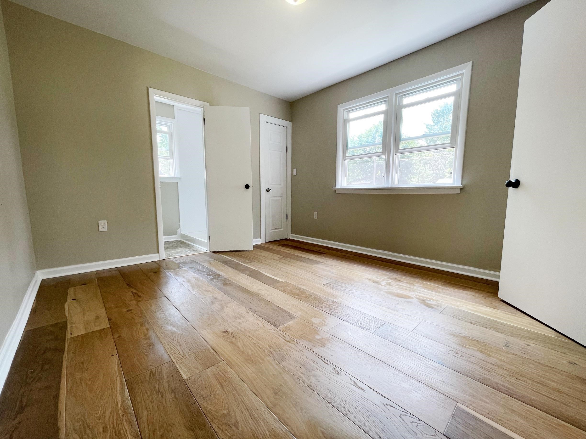 503 5th Street Grottoes, VA 24441 - Photo 17 of 24 a view of an empty room with wooden floor and a window