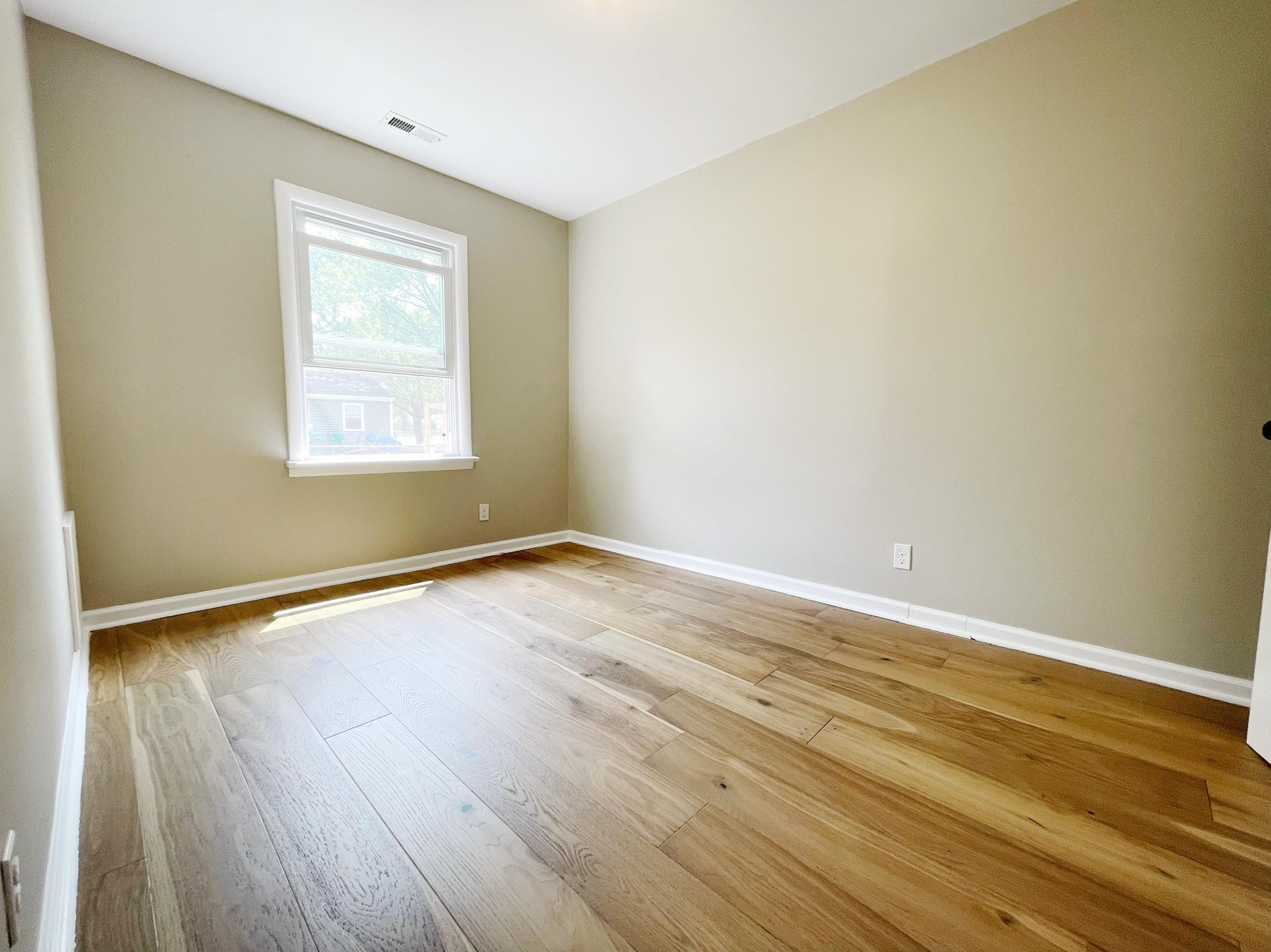 503 5th Street Grottoes, VA 24441 - Photo 19 of 24 a view of an empty room with wooden floor and a window