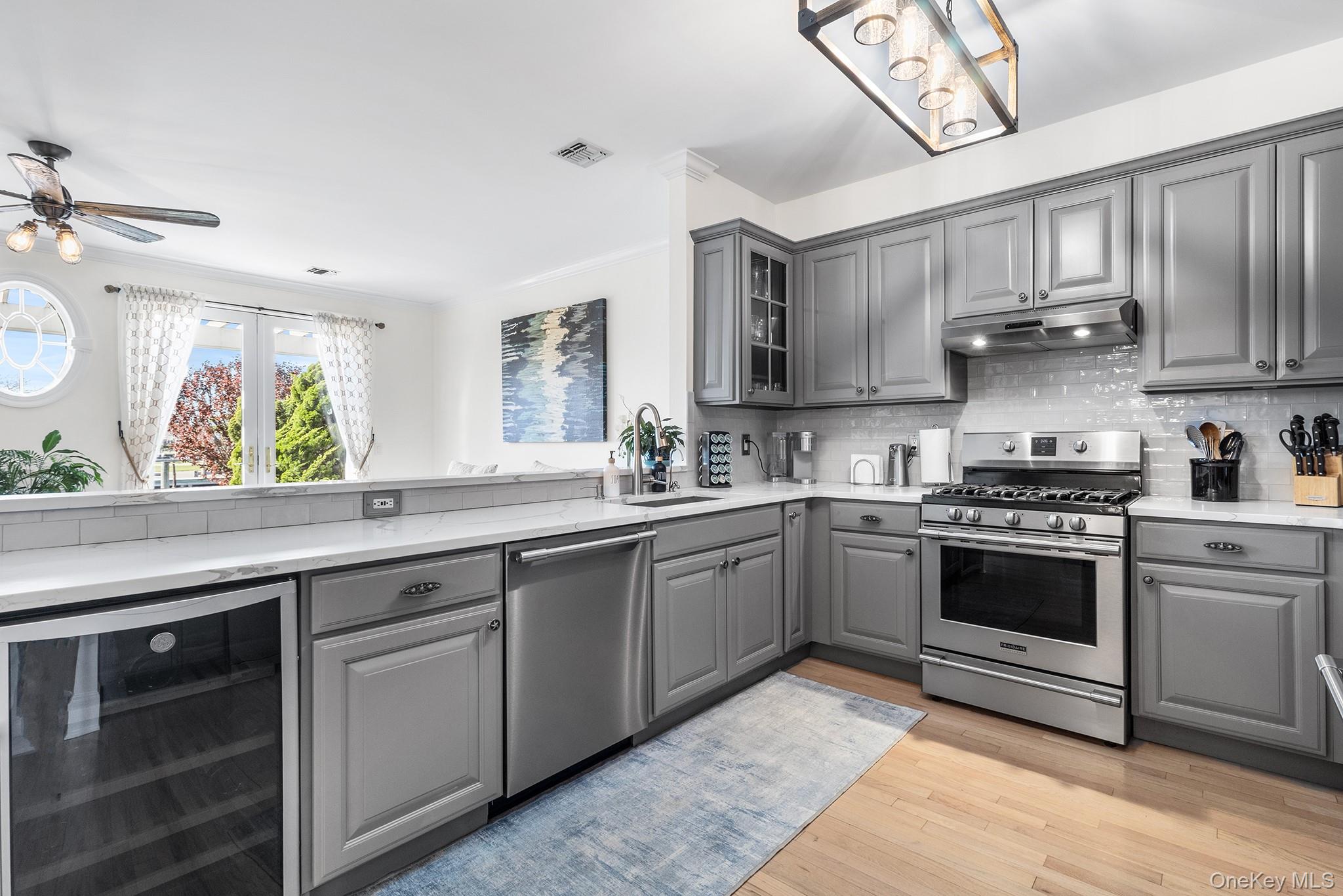 7 Salt Meadow Road, Unit 7 Babylon, NY 11702 - Photo 11 of 35 a kitchen with stainless steel appliances granite countertop a sink and cabinets
