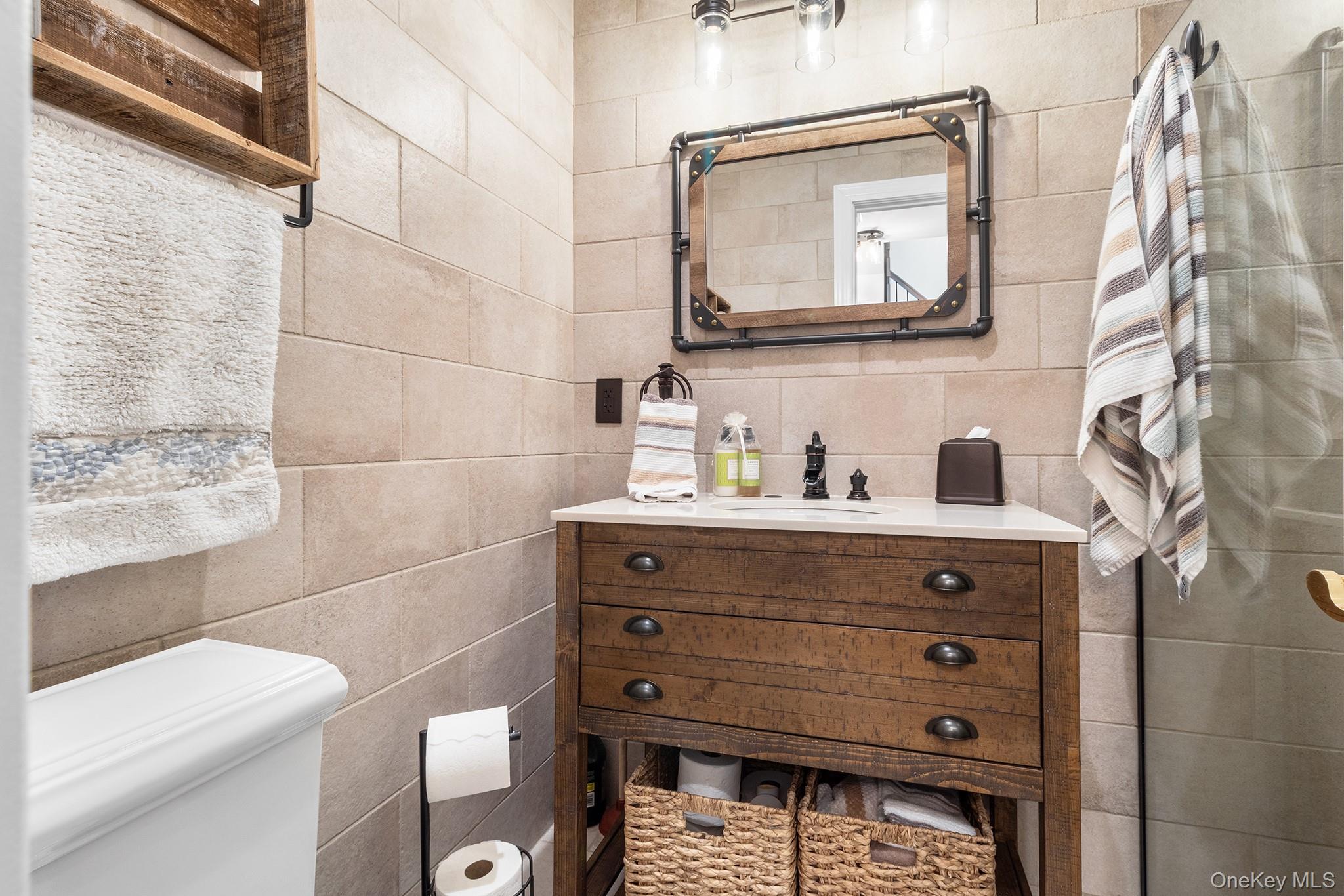 7 Salt Meadow Road, Unit 7 Babylon, NY 11702 - Photo 14 of 35 a bathroom with a toilet a sink and mirror