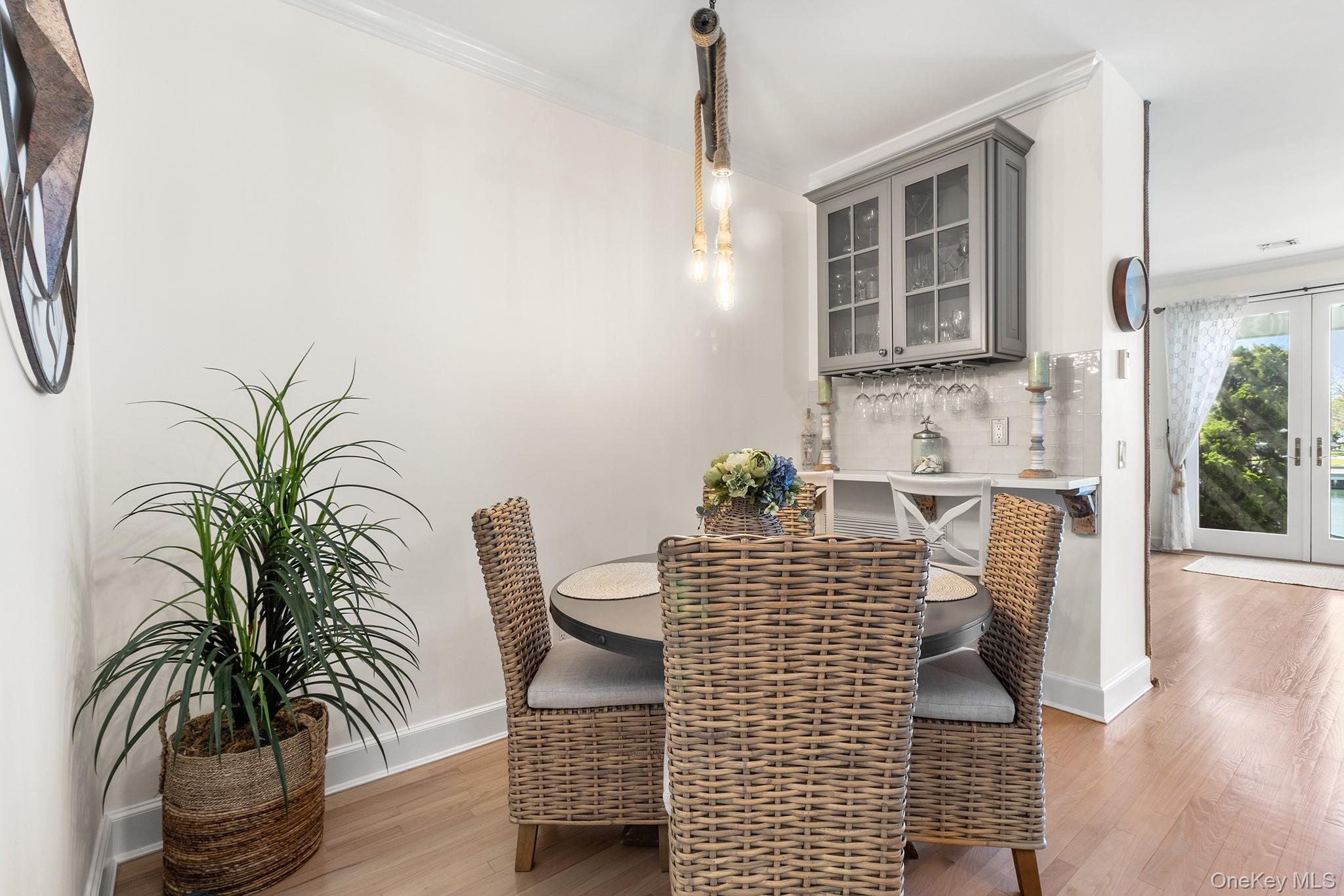 7 Salt Meadow Road, Unit 7 Babylon, NY 11702 - Photo 15 of 35 a dining room with furniture and wooden floor