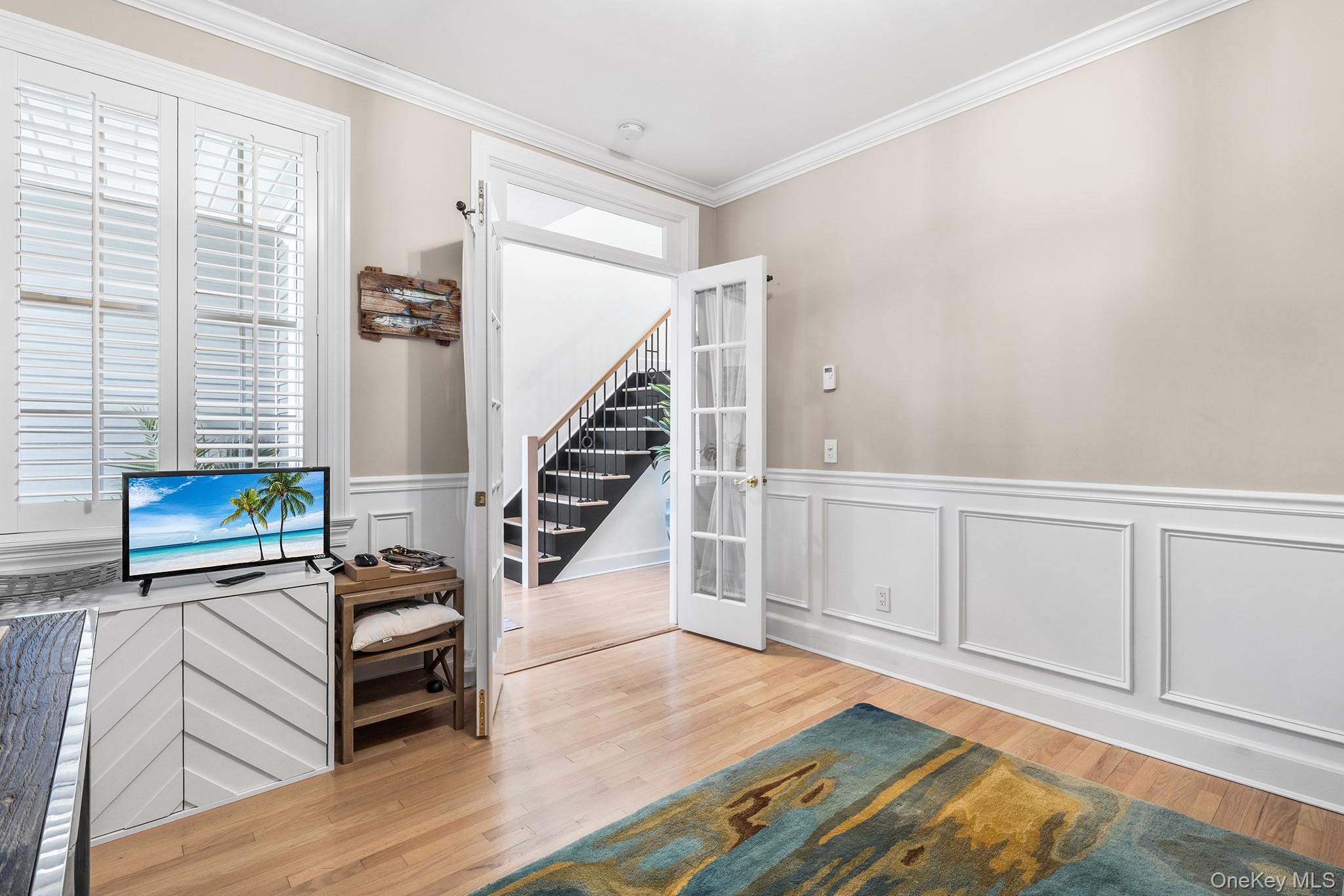 7 Salt Meadow Road, Unit 7 Babylon, NY 11702 - Photo 18 of 35 a view of a livingroom with wooden floor and stairs