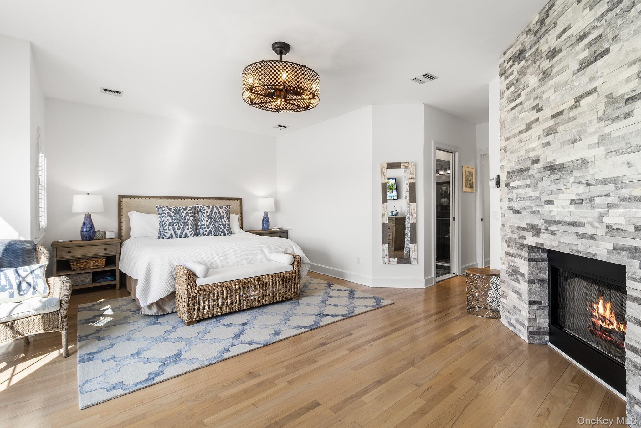 7 Salt Meadow Road, Unit 7 Babylon, NY 11702 - Photo 20 of 35 a bedroom with a bed and a fireplace