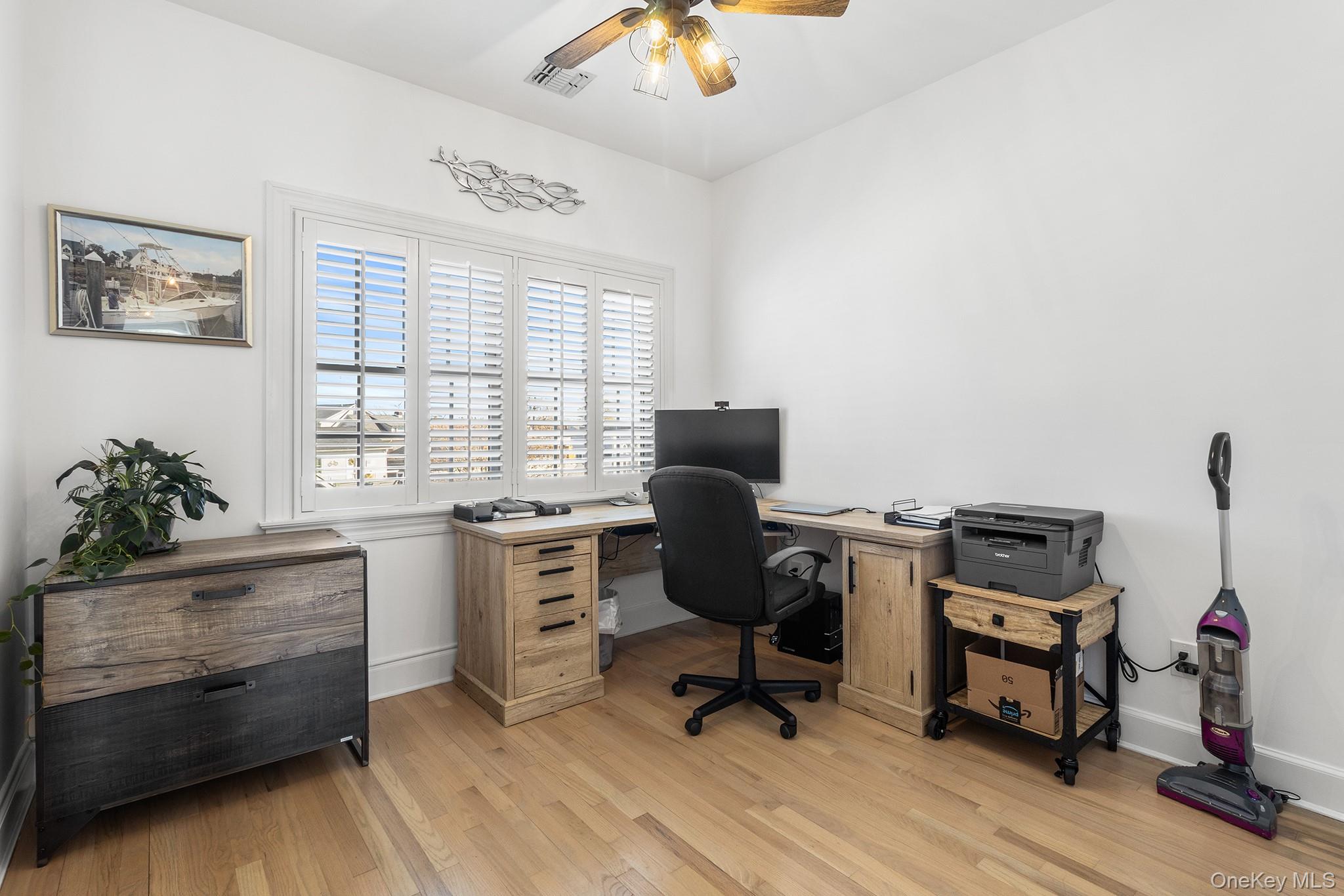7 Salt Meadow Road, Unit 7 Babylon, NY 11702 - Photo 22 of 35 a view of a workspace with furniture and a window