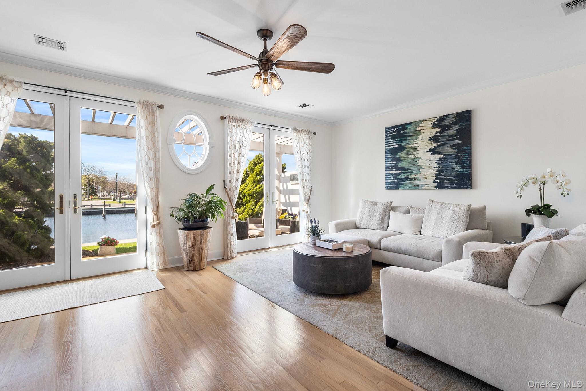 7 Salt Meadow Road, Unit 7 Babylon, NY 11702 - Photo 8 of 35 a living room with furniture and a large window