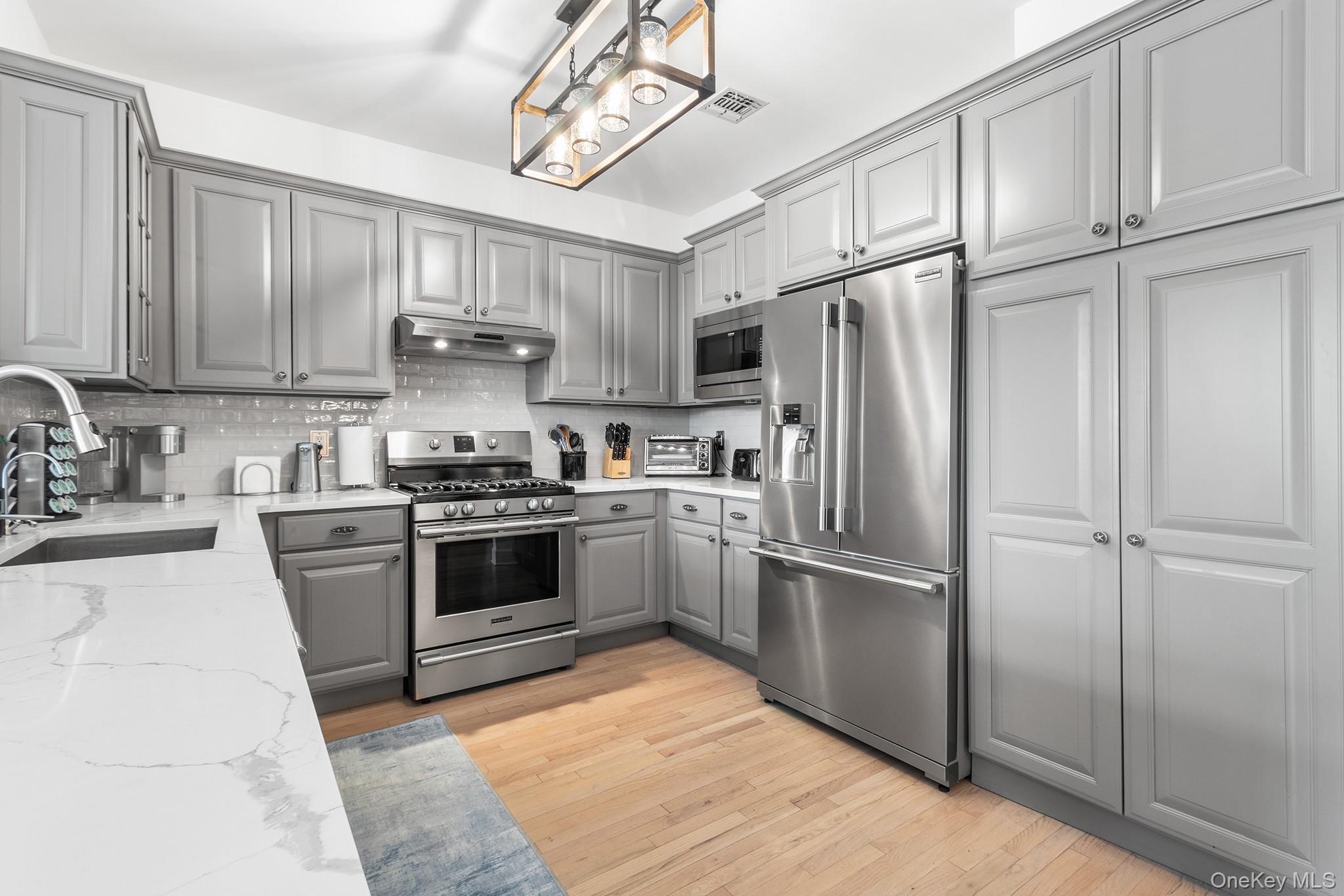 7 Salt Meadow Road, Unit 7 Babylon, NY 11702 - Photo 10 of 35 a kitchen with cabinets stainless steel appliances and a window