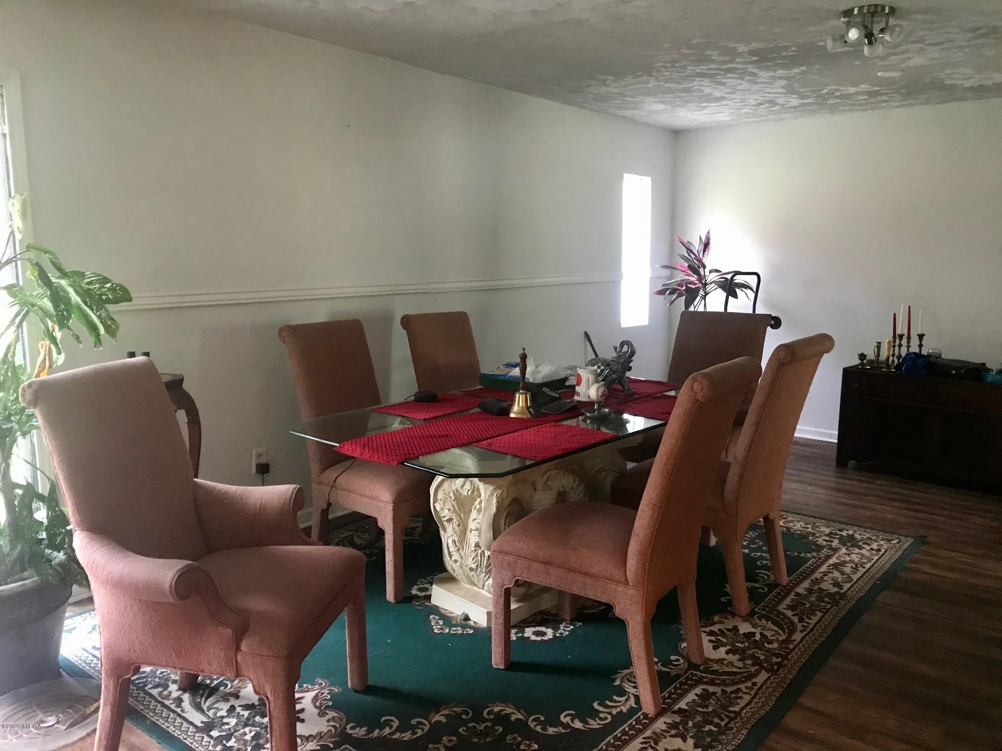 8765 Hopewell Road Lizella, GA 31052 - Photo 3 of 11 a dining room with furniture and wooden floor