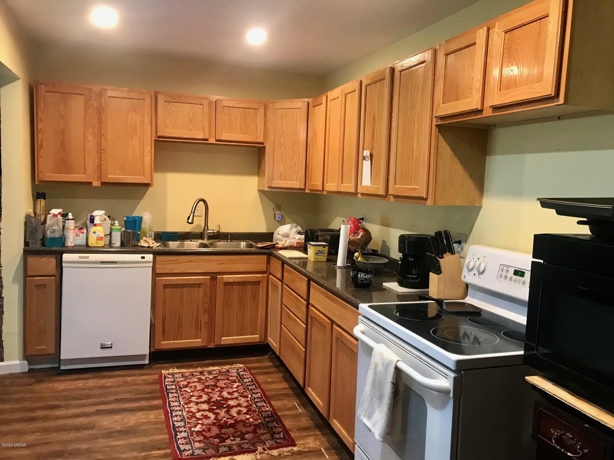8765 Hopewell Road Lizella, GA 31052 - Photo 6 of 11 a kitchen with a sink stove top oven and cabinets
