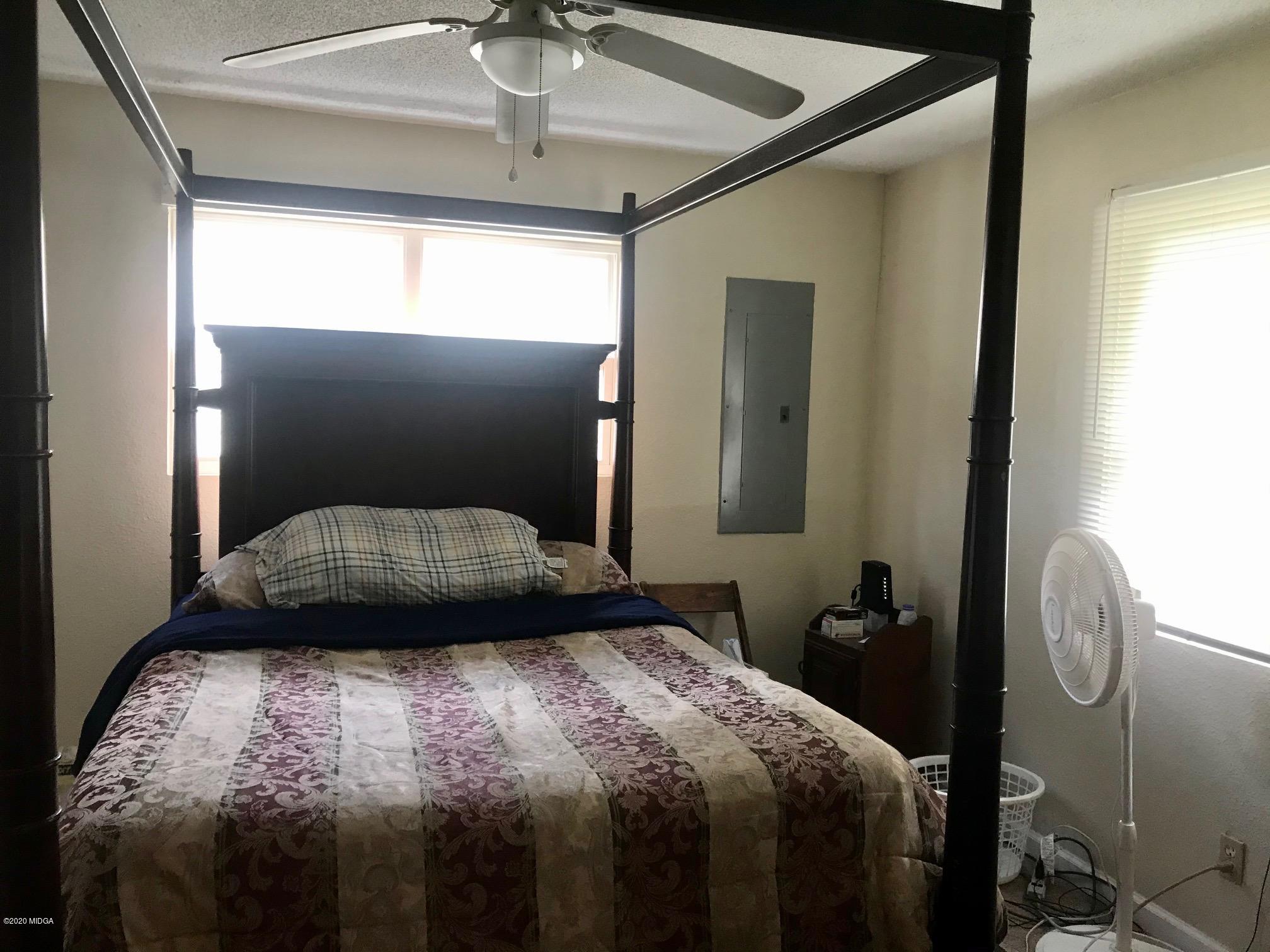 8765 Hopewell Road Lizella, GA 31052 - Photo 7 of 11 a bedroom with a bed and a chandelier
