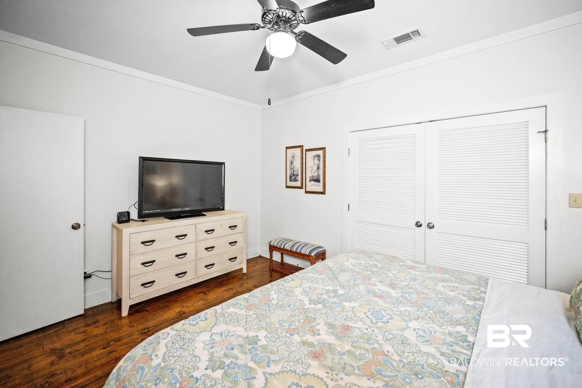 25773 Canal Road, Unit 18 Orange Beach, AL 36561 - Photo 13 of 44 Bedroom featuring dark wood-type flooring, ornamental molding, a closet, and a ceiling fan