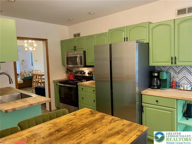 a kitchen with a refrigerator and a sink